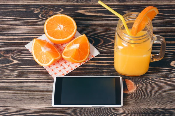 Oranges, Juice and Mobile Phone. Technology Concept
