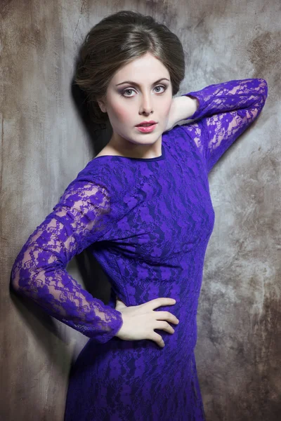 Sexy woman in violet lace dress.