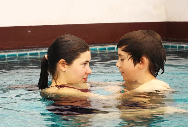 brother and sister portrait in the swimming pool