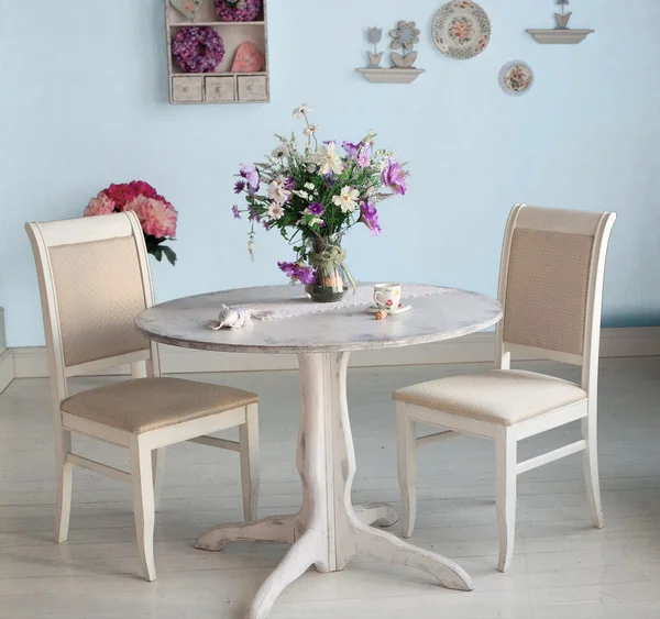 Dining room interior with flowers decorative plates white wall