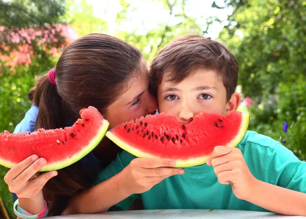 Cute siblings couple with water melon slices