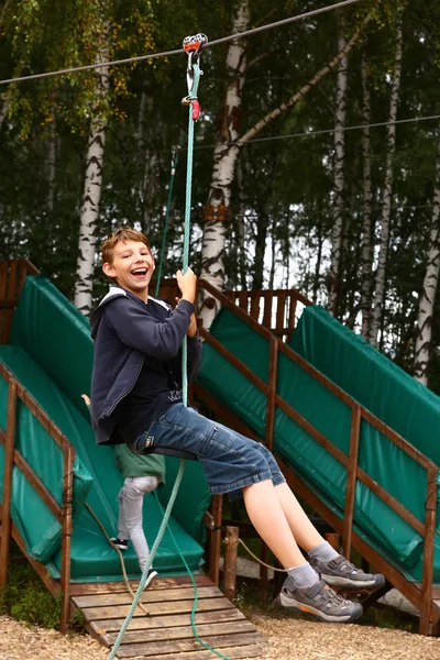 Boy in  summer sport  park on cable railway attraction