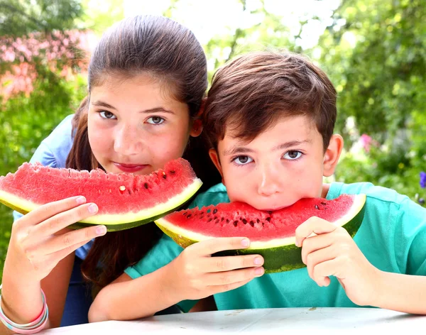 Cute   siblings couple with water melon slices