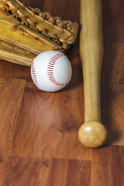 Baseball bat with ball and baseball glove on wood background