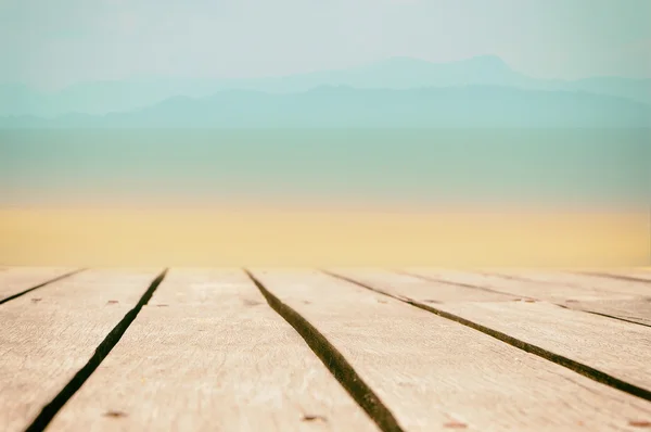 Wooden table top on tropical beach background, display products idea