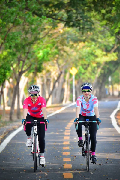 BANGKOK THAILAND - MAY 14: Two sportswoman ride bike at Nongbon Water Sports Center in BANGKOK THAILAND on MAY 14, 2016