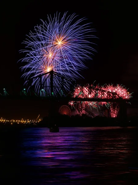 Fireworks light up the sky with dazzling display.Big colorful fireworks explode in Montreal fireworks festival in dark sky, July, Independence,  Montreal, Canada