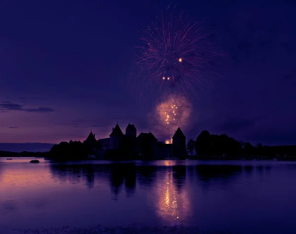 Big colorful fireworks explode with nice reflection on a water, July, Independence, fireworks with old castle in the background