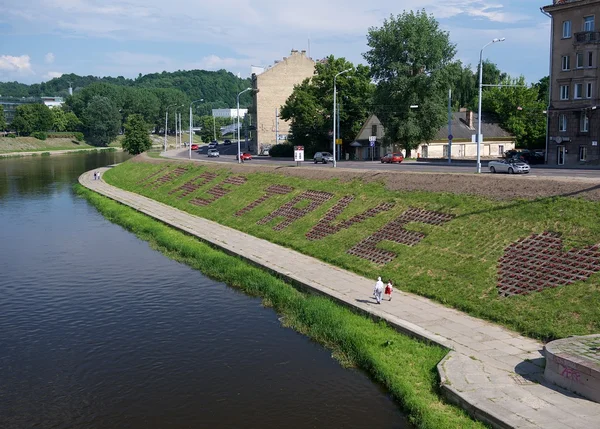 Vilnius, Lithuania - May 9, 2013:People walking near the main river Neris of Lithuanian capital in Vilnius on 9 May, 2013. Bank of river Neris in Vilnius, capital of Lithuania, baltic country