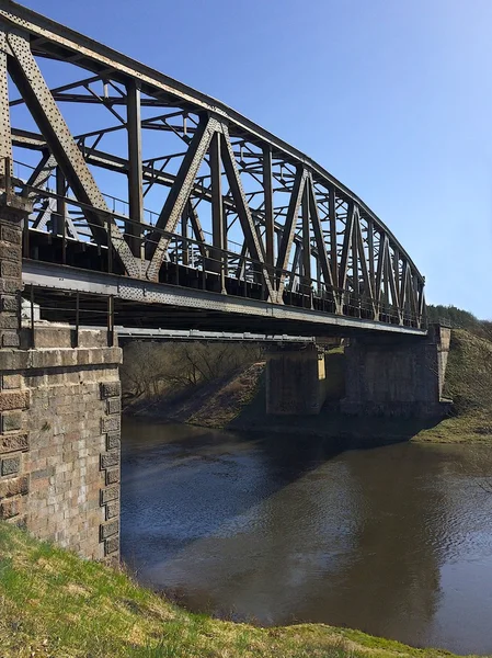 Old bridge across the Neris river in Lithuania in early spring, old railway bridge, Lithuania