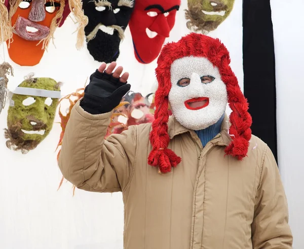 VILNIUS, LITHUANIA - feb 7: person in traditional mask selling various goods in flea market on Feb 7, 2016 in Vilnius, Lithuania. Traditional crafts fair with masks in Lithuania, 7 weeks before Easter