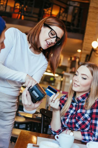 Young Woman Paying A Bill By Credit Card