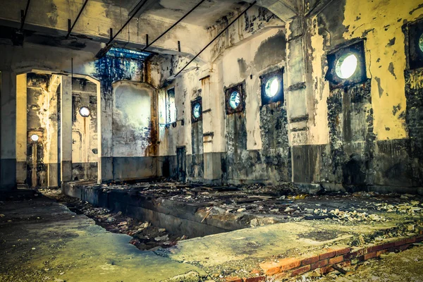 Abandoned building with light shining through round windows