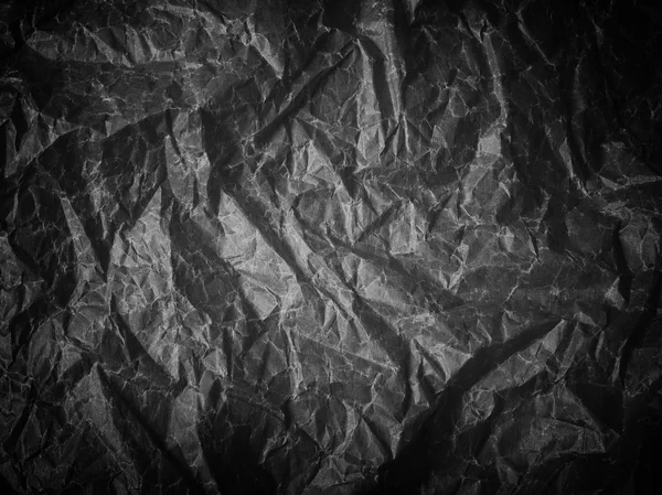 A crumpled sheet of paper black