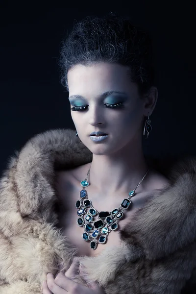 Beautiful girl in the image of the Snow Queen in a fur coat