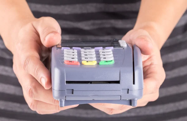 Cashier Holding Credit Card Machine