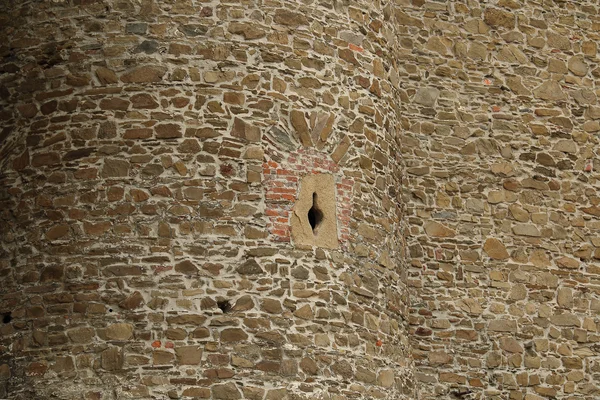 Detail of medieval castle wall with small arrow slit