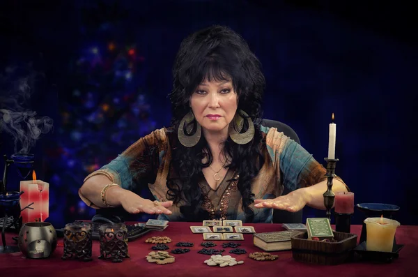 Portrait of mature clairvoyant doing cards reading