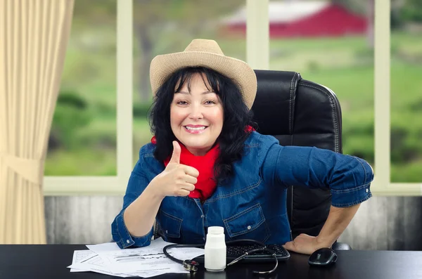 Rural doctor talks up a pills on her desk