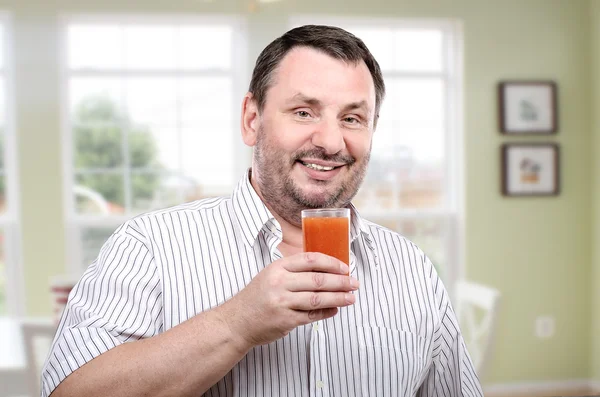 Cheerful guy is fond of antioxidant smoothie
