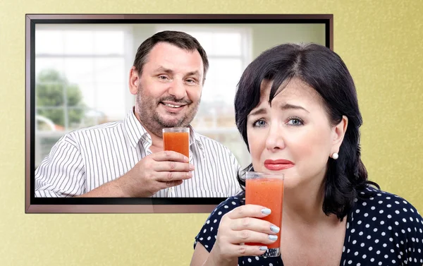 Woman is being made to drink a healthy smoothie