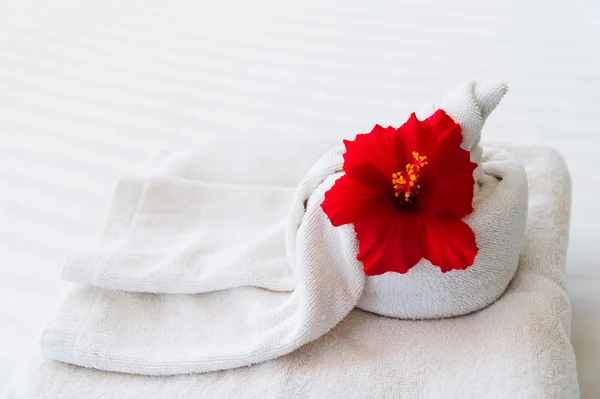 White towel with a flower on white background