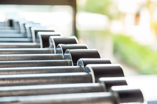 Dumbbells weight training equipment in gym close up