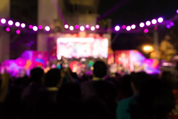 Blurred background  of concert crowd in front of bright stage li