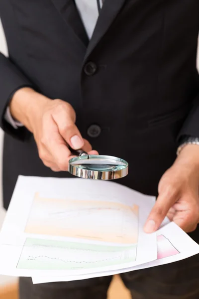 Close up portrait of handsome young man reading a chart report t