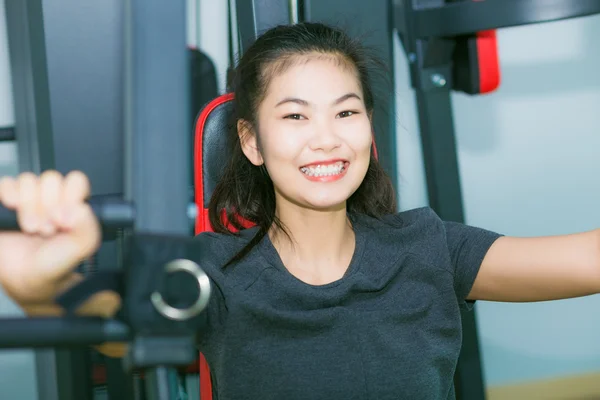 Young asian woman working exercise in the gym