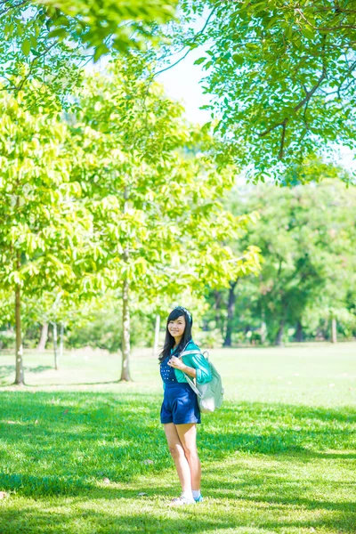 Woman in park outdoor with knapsack