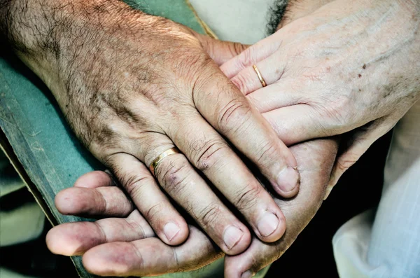 Tinted color image of old married couples hands. horizontal