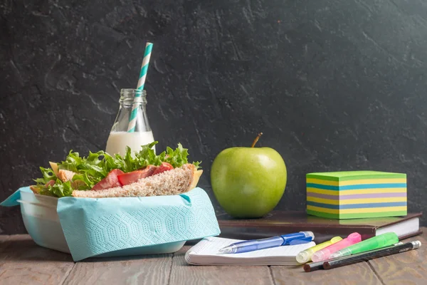 School lunch with sandwich, milk and apple