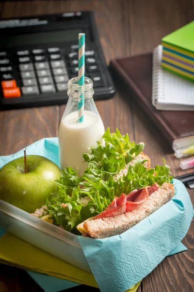 School lunch with sandwich, milk and apple