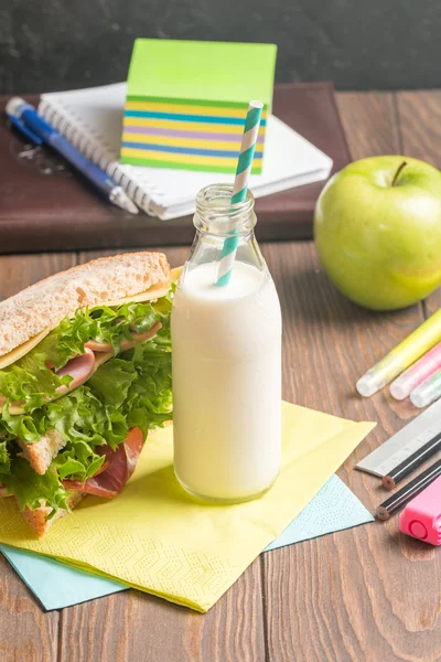 School lunch with sandwich, milk and apple