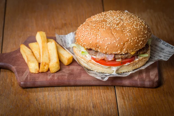 Delicious burger  on paper and fries