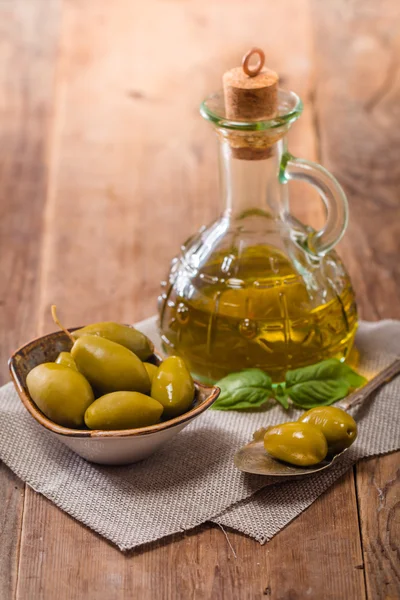 Olive oil and olives in bowl