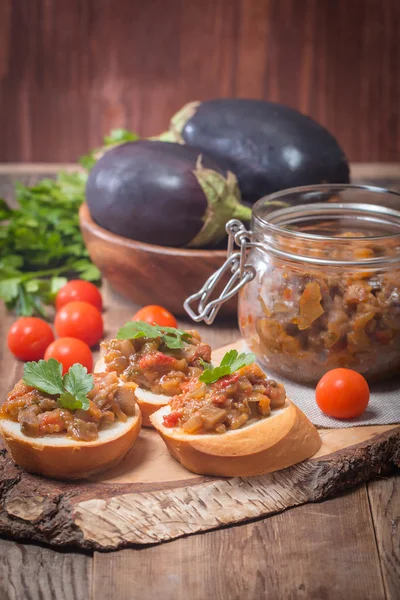 Eggplant caviar in a glass jar with croutons