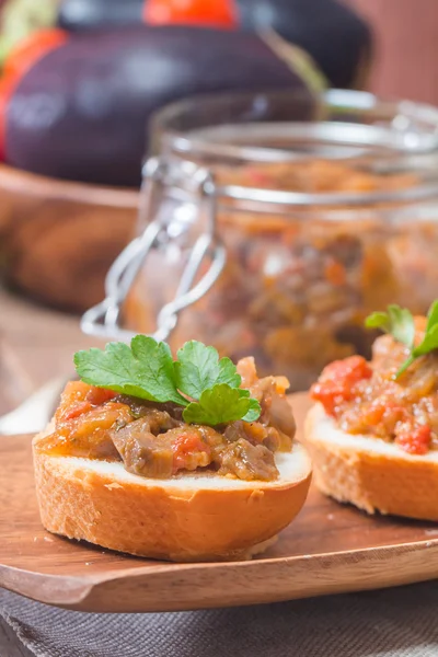 Eggplant caviar in a glass jar with croutons
