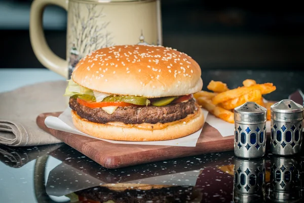 Cheeseburger served  with French Fries and Beer