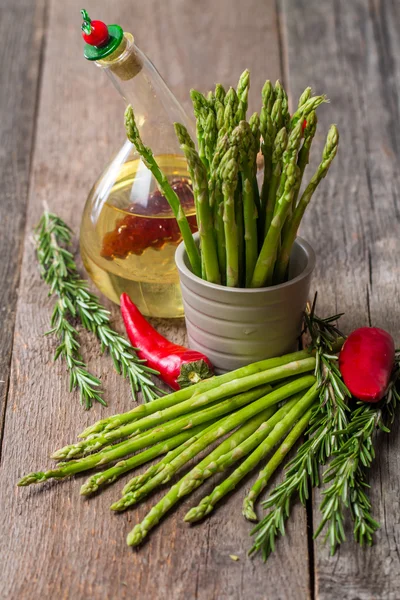 Still life with olive oil asparagus, avocado, pepper and rosemar