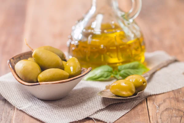 Olive oil and olives in bowl