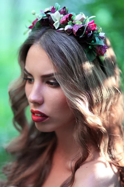 Girl with big lips,woman wearing a crown,rim on the head,gloomy image,gothic image,dark lipstick,wood nymph,portrait,gothic,fairy,facial features,full lips,mermaid,goddess,fairy-tale image,head piece,color,flower wreath,Flowers in her hair.
