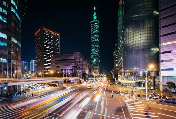 Traffic on Xinyi Road and view of Taipei 101 at night, in Taipei