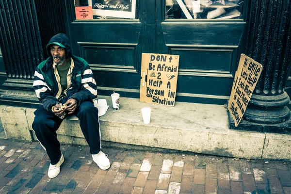 Homeless man with signs in Richmond, Virginia.