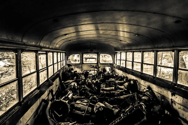 Junk inside an old school bus.
