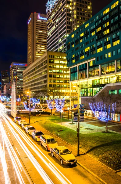 Long exposure of traffic moving past modern buildings on Pratt S