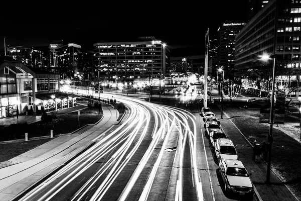 Long exposure of traffic moving past modern buildings on Pratt S