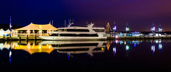 Pier and boat reflecting in the Potomac River at night, in Natio