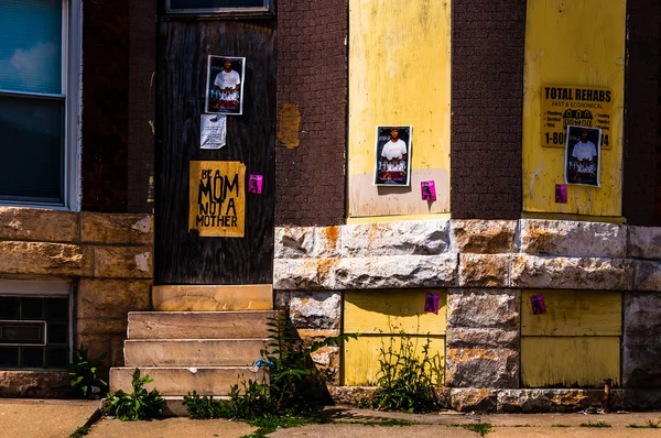 Posters on the front of an abandoned house in Baltimore, Marylan